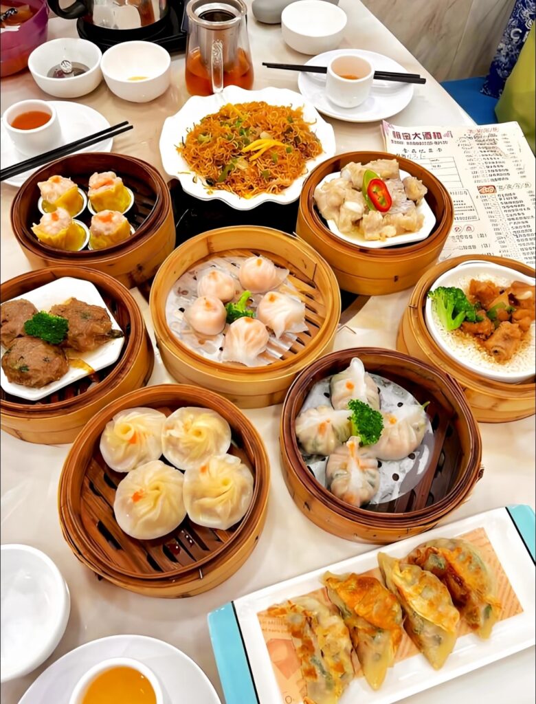 Guangzhou Yum Cha dim sum spread with bamboo steamers and tea